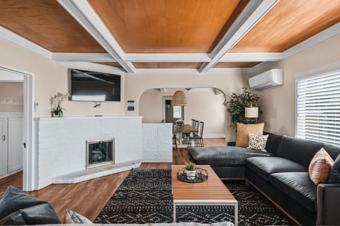 Spacious living room with plenty of seating featuring smart TV with streaming services