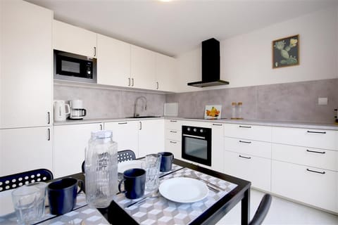 Modern kitchen fully fitted with dining area for four guests