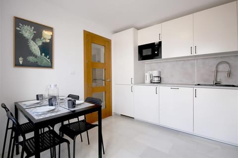 Another picture of the modern kitchen with dining area for four guests