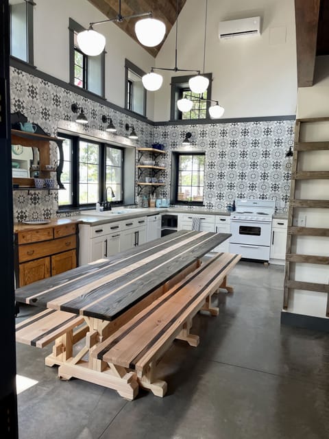 Bright and sunny kitchen with 11 foot long table for dining and game playing.