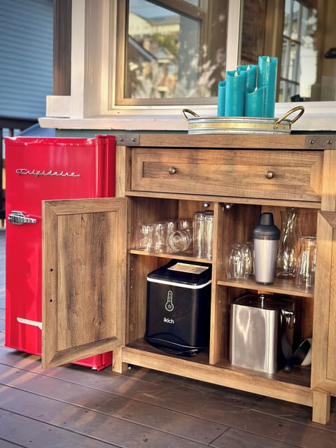Outdoor fridge and equipped bar area.