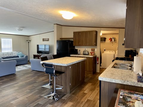 Fully equipped laundry room, next to the kitchen with washer and dryer. 