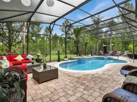 Relax in the screened-in pool area with scenic nature views and ample seating.