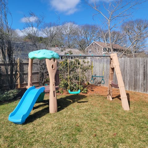 fenced-in yard with playground 