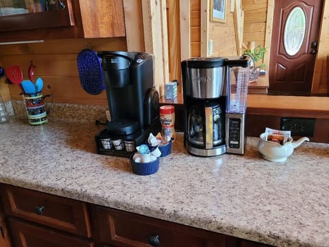 Kurieg and conventional coffee makers with suger, creamers and coffee