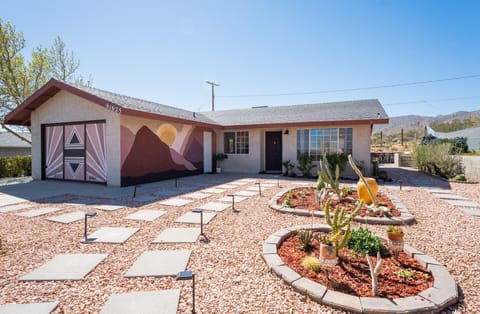 As you approach the property, the stunning front wall murals capture your attention with their vibrant colors and intricate designs.