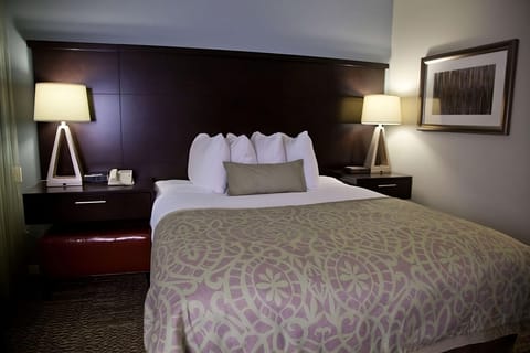Sink into a cozy king bed under warm bedside lighting.