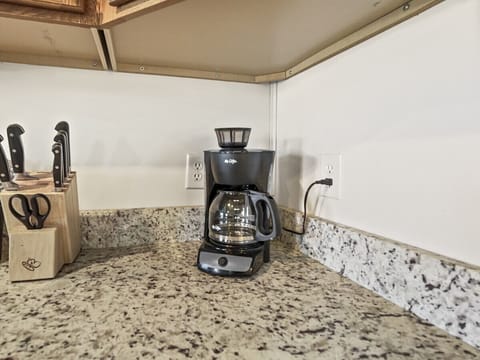 There is a drip coffee pot in the condo