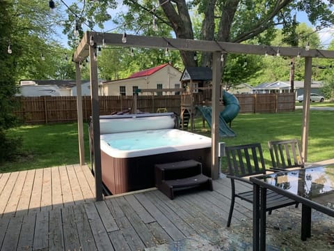 Unwind in the private hot tub under twinkling string lights ✨. Perfect for evening soaks, surrounded by a spacious deck, dining area, and fenced-in yard.