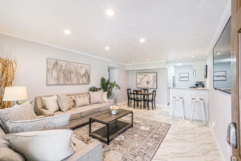 Living room with open floor plan with Smart TV.