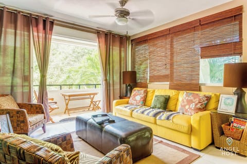 Feel at home in the vibrant living room, with cozy seating and abundant natural light.