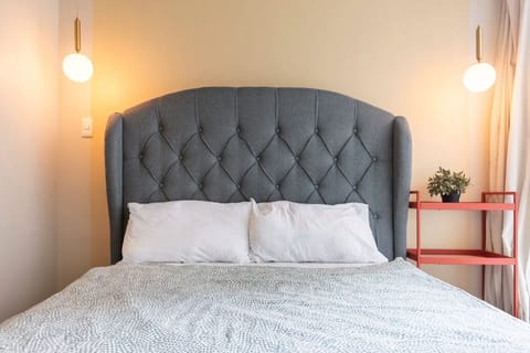 Queen sized bed with drop lights and working table