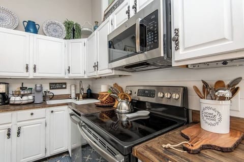 Kitchen view of electric stove & dishwasher.