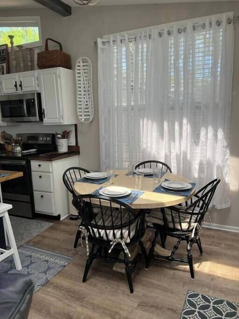 Dining area in kitchen with seating for 4 at table and seating for 4 at island.