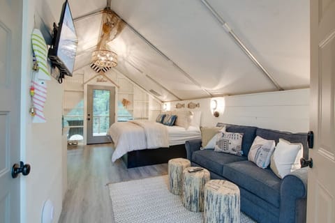 Spacious glamping tent featuring a private hot tub, king bed, and scenic views. Experience luxury camping in the heart of North Alabama Fishing Themed
