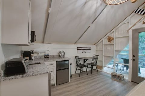Glamping tent featuring a fully stocked kitchenette with a dishwasher, coffee maker, and more  for added fun and relaxation.