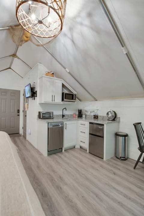 Spacious glamping tent featuring a complete kitchenette with modern appliances and tasteful décor,perfect for a comfortable and entertaining retreat