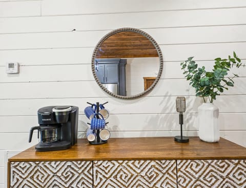 Start your day right in this charming coffee nook, complete with a stylish cabinet and modern appliances.