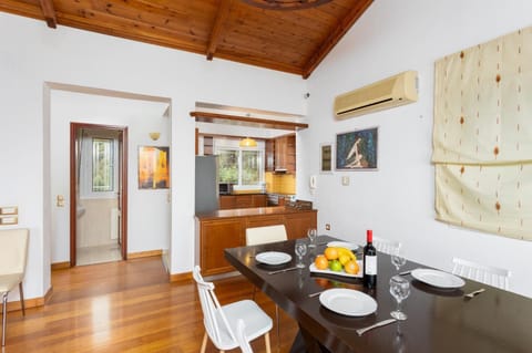 Open-plan living room with sofa, dining area, kitchen, ornamental fireplace, A/C, WiFi internet, satellite TV, and sea views