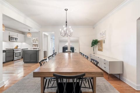 Open concept dining room and kitchen with a table that seats 10 + 2 bar stools.