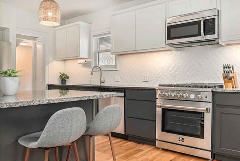 A breakfast bar at the kitchen island provides extra seating for 2