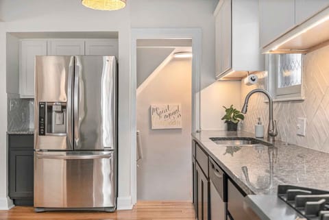 A stairwell in the kitchen leads to the downstairs living space