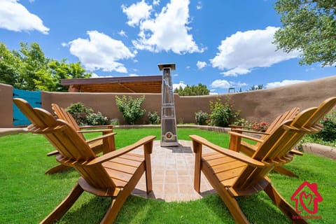Courtyard with a cozy pellet stove and furnished with four comfortable chairs