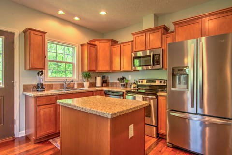 You won't find this kitchen area lacking. Fit with a fridge, microwave, oven/stovetop, and an island to boot!