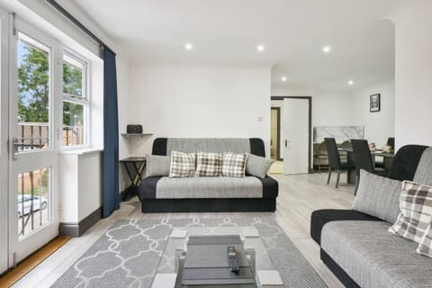 Two stylish and comfortable sofa beds and positioned to face a charming patio