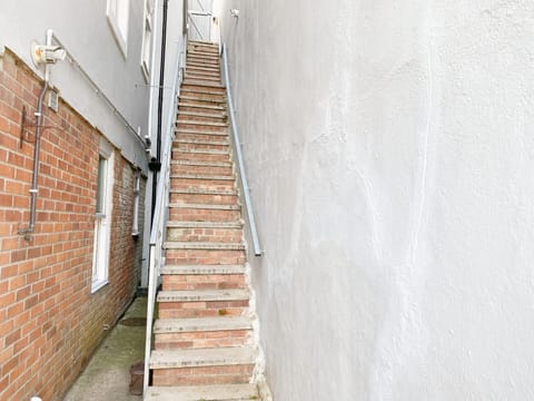 Steps down to the apartment from street level