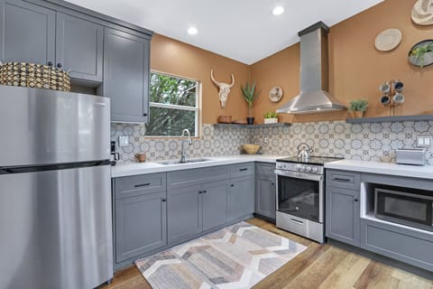 The cabin has a modern kitchen with stainless range/oven combo.