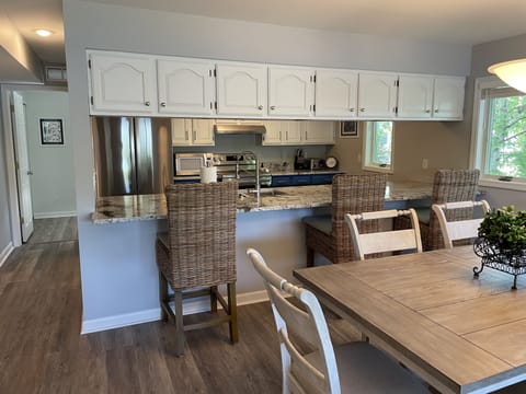 ...Kitchen area in the background with abundance of cabinetry.