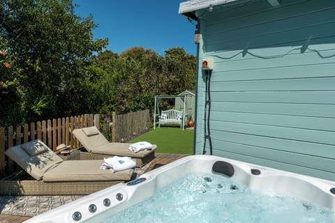 Hot tub and loungers in the pretty garden