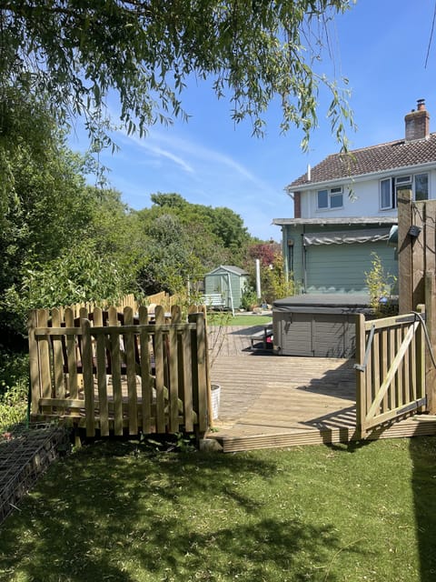 DaneSide from end of garden, under the willow, with hot tub and summer room.