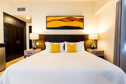 Drift off in crisp linens framed by warm, modern lighting.