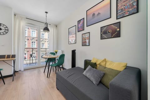 Modern studio with a double bed, a single sofa bed, dining area and access to balcony.