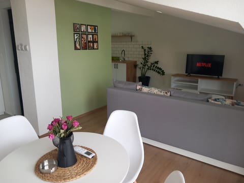 Air-conditioned open-plan living room with kitchen, dining, and sitting areas