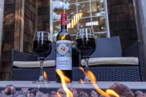 Drink your favorite wine while sitting by the fire table
