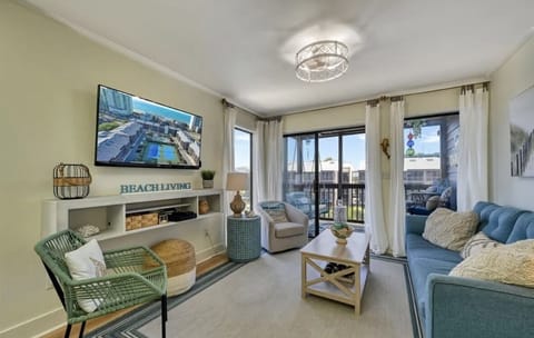 living room: ample seating for all, pull out sofa bed, flat screen TV, pool view