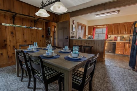 The dining area features seating for six, plus additional seating for two at the kitchen island.