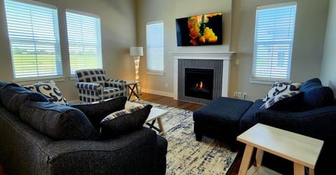 Living room with plenty of light, 58" Smart TV, gas fireplace!