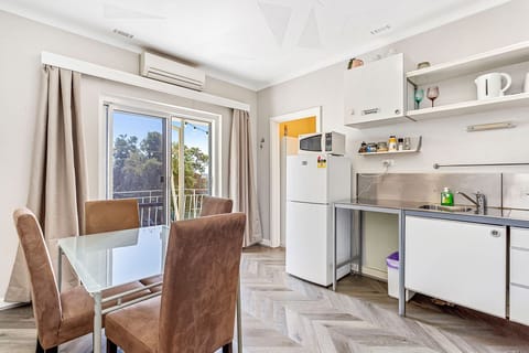 Imagine enjoying a meal at this inviting dining table, surrounded by natural light and views of the outdoors.