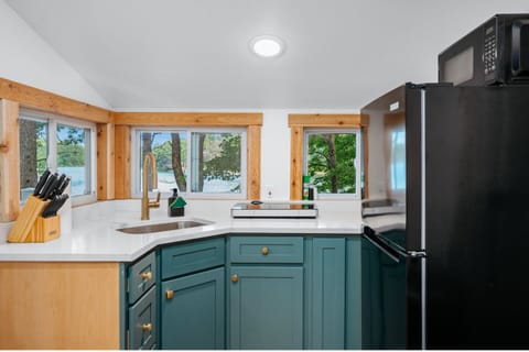 Kitchen: Modern design meets nature with views and stylish appliances for culinary adventures!