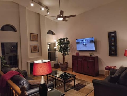 The cozy living room features a 55-inch Roku TV and wood-burning fireplace.