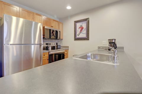 Your fully equipped kitchen awaits with gleaming stainless steel appliances and warm wood cabinetry. Prepare your favorite meals with modern conveniences at your fingertips.