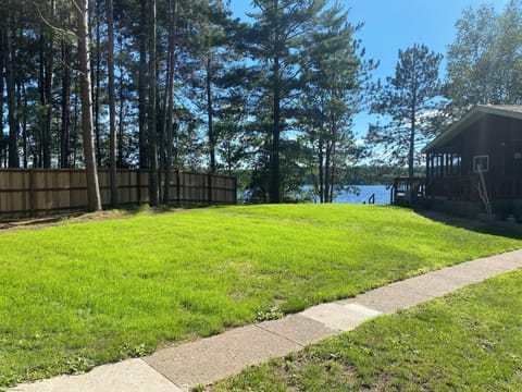 Cedar privacy fence and large open side yard with fire ring.