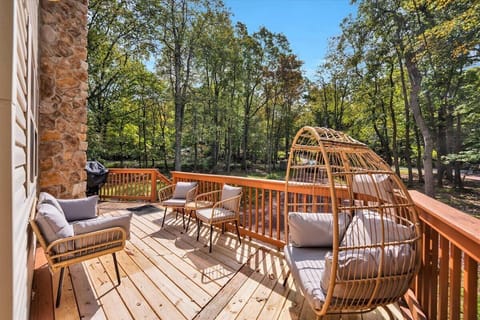 Front deck with egg chair, sofa, chairs, coffee table