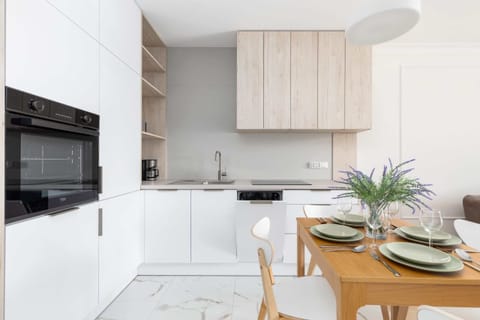 Fully equipped kitchenette with convenient cabinets, modern appliances and dining area.