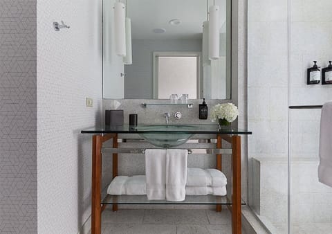 Refresh with a modern glass sink and plush folded towels.