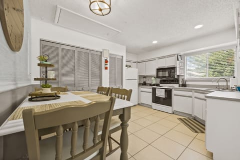 A dining room table for four, and a fully appointed kitchen + laundry room!